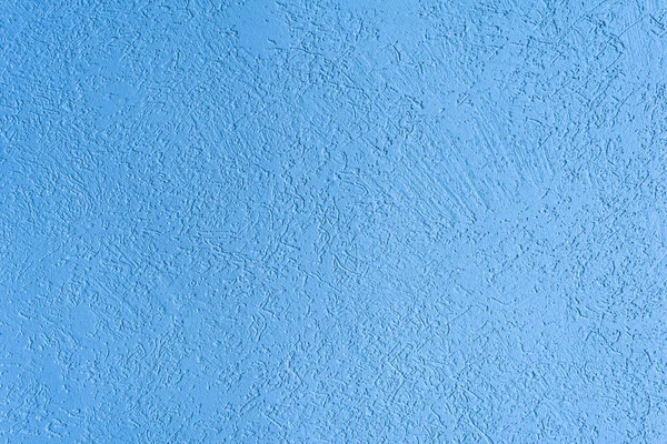 The blue texture of the surface of the wall covered with decorative plaster of the woodworm type, close-up architecture abstract background — Stock Image Blue Texture Surface Wall Covered Decorative Plaster Woodworm Type Close Stock Picture