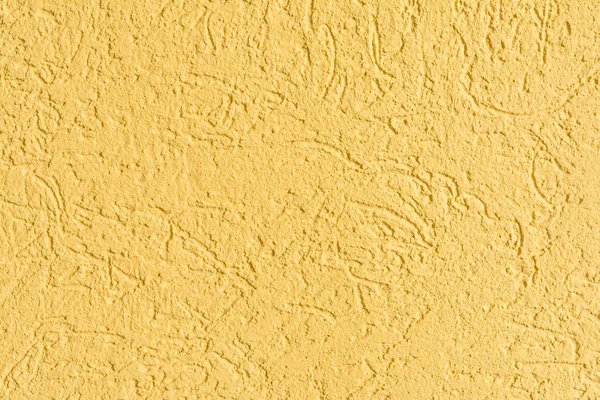 The yellow texture of the surface of the wall covered with decorative plaster of the woodworm type, close-up architecture abstract background — Stock Image Yellow Texture Surface Wall Covered Decorative Plaster Woodworm Type Close Stock Picture