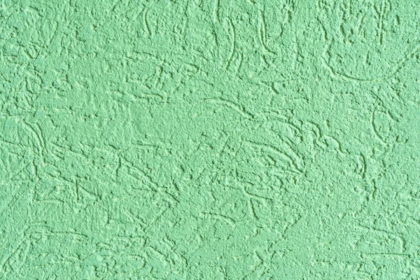 The green texture of the surface of the wall covered with decorative plaster of the woodworm type, close-up architecture abstract background — Stock Image Green Texture Surface Wall Covered Decorative Plaster Woodworm Type Close Royalty Free Stock Photos