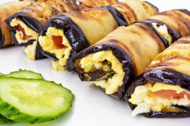 Peynir Rulo gelen Patlıcan dolması, domates ve dilimlenmiş yeşil salatalık yalan bir beyaz tabak, yemek yakın çekim arka plan, çerçeve merkezinde seçici odak