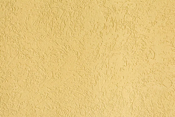The yellow texture of the surface of the wall covered with decorative plaster of the woodworm type, close-up architecture abstract background — Stock Image Yellow Texture Surface Wall Covered Decorative Plaster Woodworm Type Close Royalty Free Stock Images