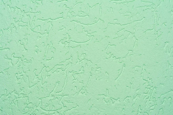 The green texture of the surface of the wall covered with decorative plaster of the woodworm type, close-up architecture abstract background — Stock Image Green Texture Surface Wall Covered Decorative Plaster Woodworm Type Close Royalty Free Stock Photos