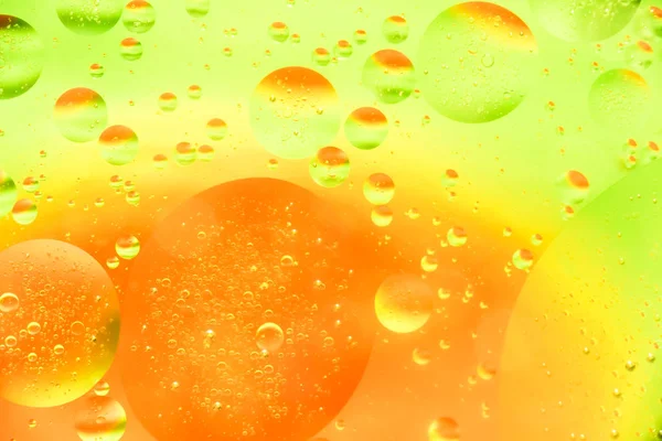 Water and oil bubble yellow orange background. Macro shot of beautiful water and oil bubble background , with small and big bubbles