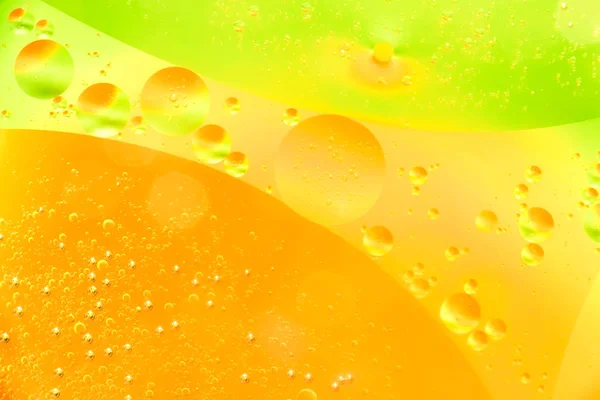 Water and oil bubble yellow orange background. Macro shot of beautiful water and oil bubble background , with small and big bubbles