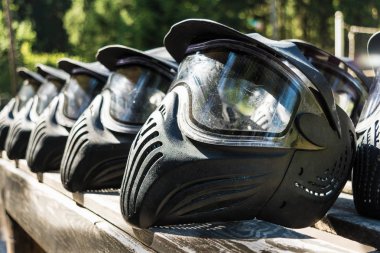 Paintball için koruyucu siyah kasklar bir oyun için hazır ahşap bir rafta yalan, yıkandıktan sonra kask dışında kurutma
