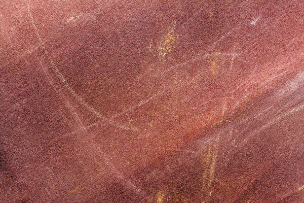 worn texture of sandpaper, close-up abstract background