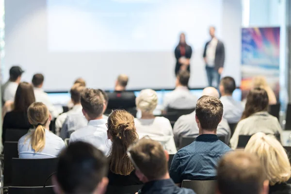 Business speakers giving a talk at business conference event.