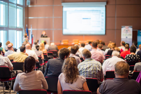 Woman giving presentation on business conference meeting.