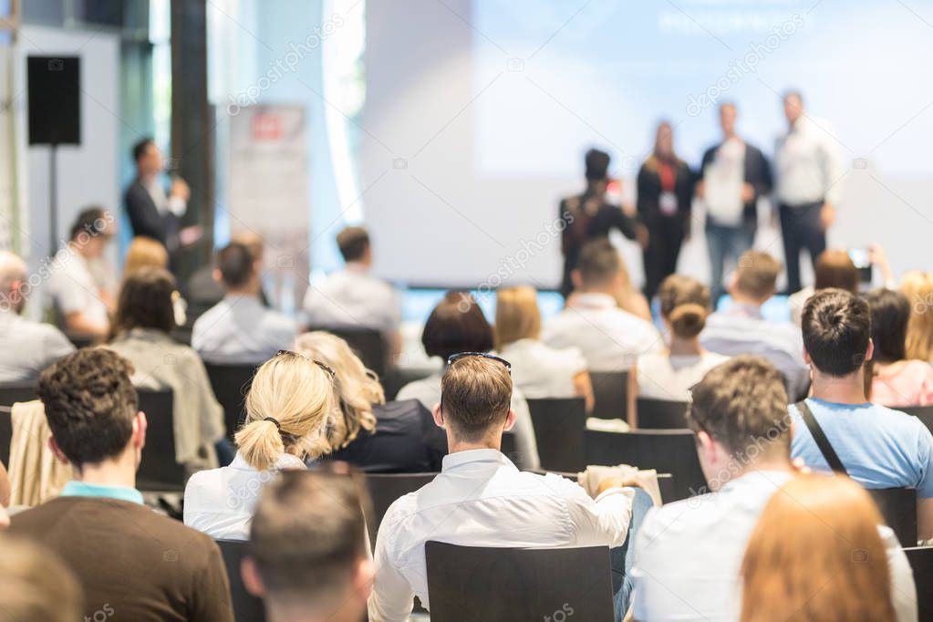 Business speakers giving a talk at business conference event.