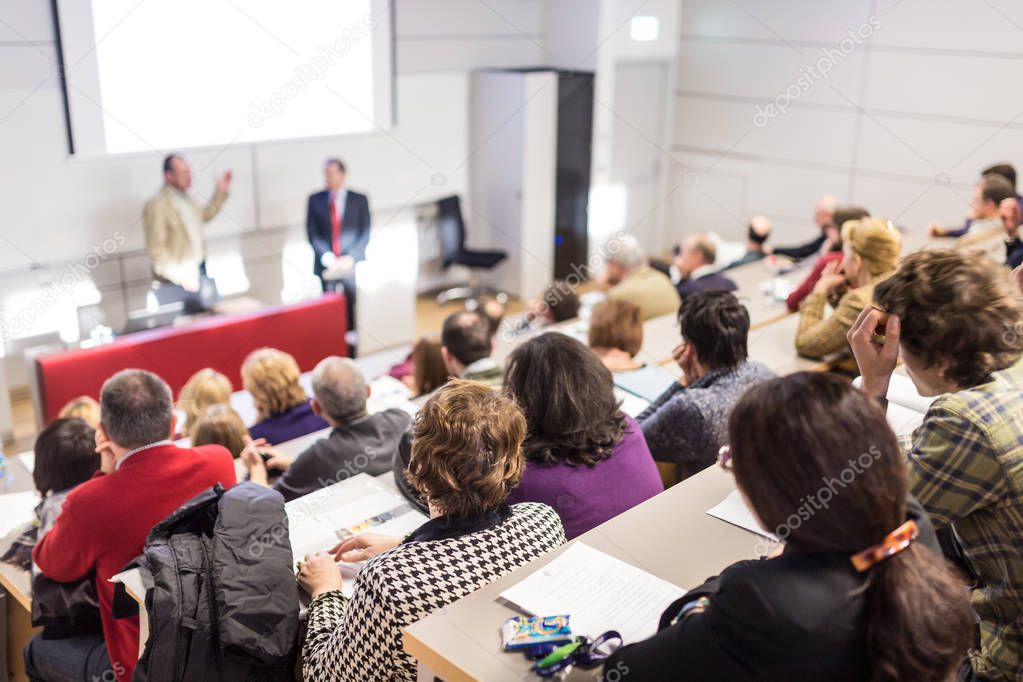 Business speaker giving a talk at business conference event.