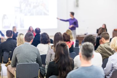 Konferans salonunda iş konferansına katılan seyirciler.