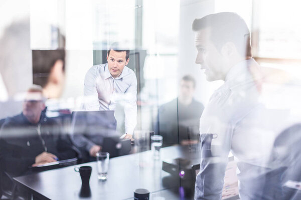 Business team brainstorming on meeting in modern corporate office.