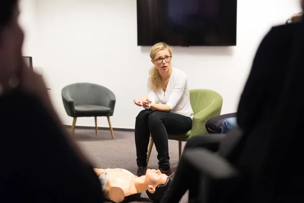 Istruttore che insegna il corso di rianimazione cardiopolmonare di primo soccorso e l'uso di defibrillatore esterno automatizzato nel laboratorio di RCP. — Foto Stock