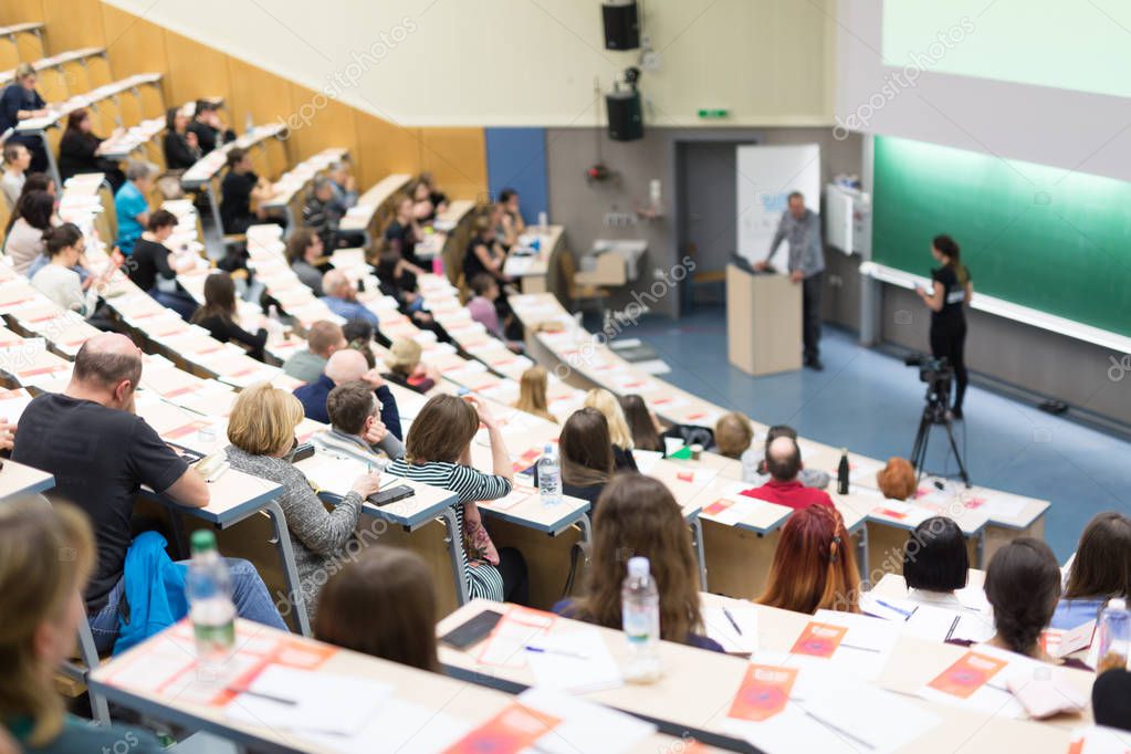 Expert speaker giving a talk at scientific business conference event.