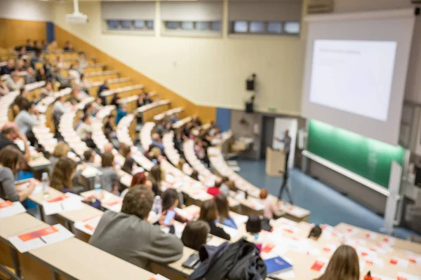 Defocused image of audience at the conference hall during academic lecture. — Stock Photo, Image