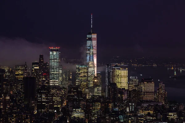 New York City skyline with lower Manhattan skyscrapers in storm at night. — Stock Photo, Image