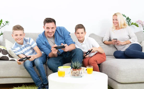 Happy young family playing videogame On TV.