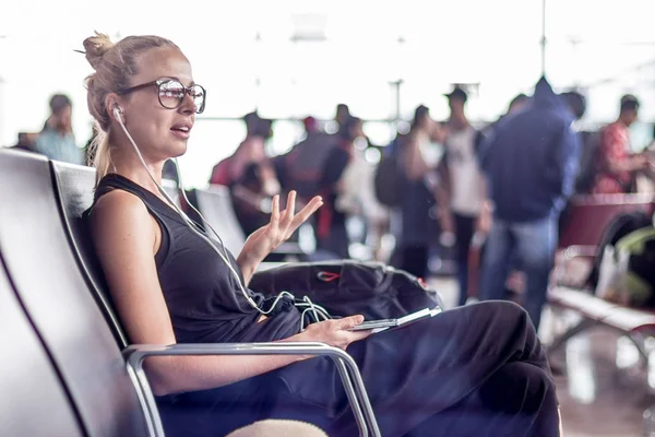 Voyageuse parlant sur un téléphone portable en attendant de monter à bord d'un avion aux portes de départ au terminal de l'aéroport asiatique . — Photo