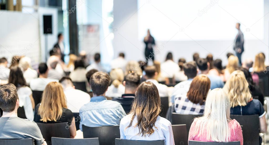 Male business speaker giving a talk at business conference event.