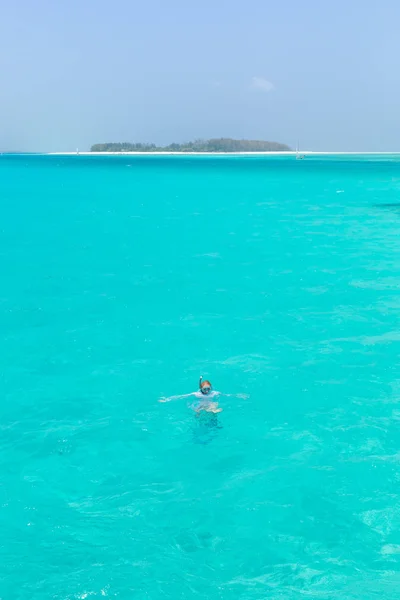 Mujer haciendo snorkel en mar claro y poco profundo de laguna tropical con agua azul turquesa. — Foto de Stock