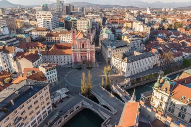 Aerial drone view of Preseren Squere and Triple Bridge over Ljubljanica river,Tromostovje, Ljubljana, Slovenia. Empty streets during corona virus pandemic social distancing measures clipart