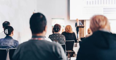 Sözcü, iş konferansında konferans salonunda konuşma yapacak. Konferans salonundaki tanınmayan insanların arka görüntüsü. İş ve girişimcilik kavramı