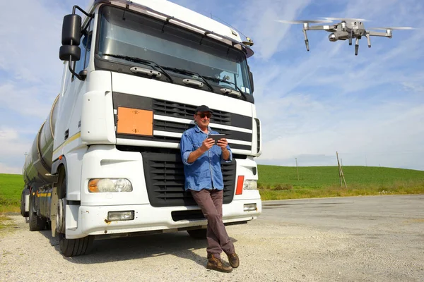 Truck driver using drone to inspecting truck