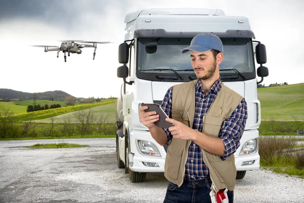 Truck driver using drone to inspect truck