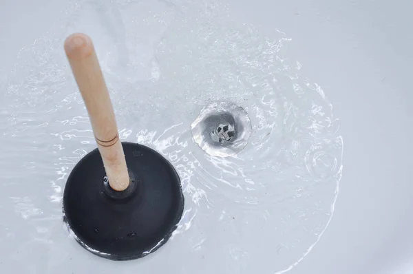 Plunger and clogged bath drain. — Stock Photo, Image