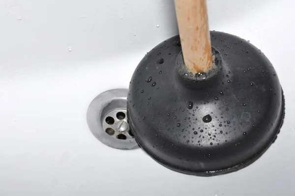 Plunger and sink drain. Stock Image