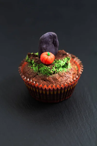 Halloween Holiday food colorful fancy brownies cupcake with gravestones and pumpkin fondant decorate