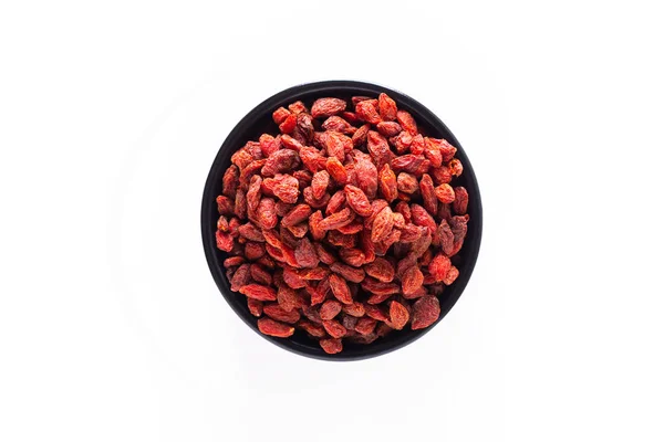 Super brain food dry Goji berry in black ceramic cup isolated on — Stock Photo, Image