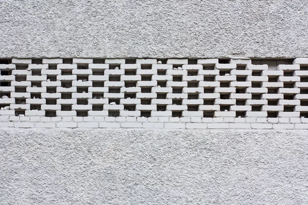 White brick wall background. Neutral texture of a flat brick wall with air vents close-up.