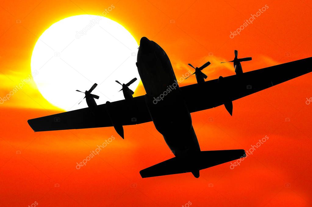 silhouette of military aircraft hercules at sunset 
