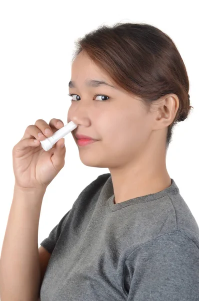 Asian girl holds nose inhaler — Stock Photo, Image