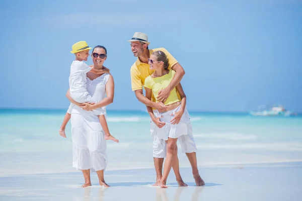 Familj på fyra ha kul på stranden — Stockfoto