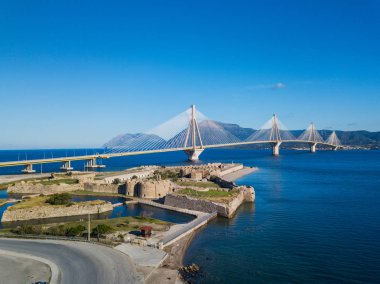 Fortress and bridge of Rio Antirio, Patra, Greece. Aerial drone birds eye view photo. clipart