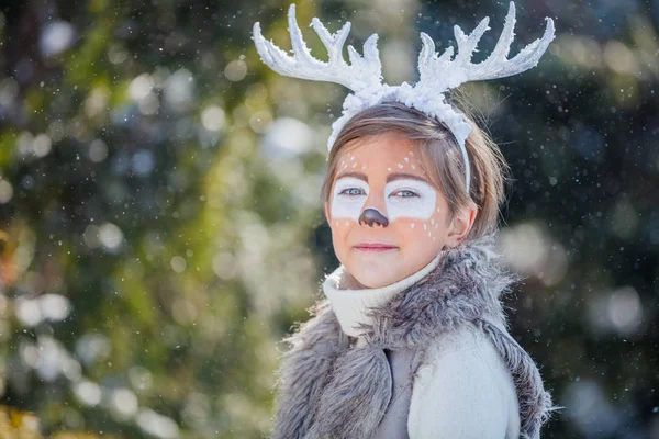 Portrait of smiling boy with funny antlers of a deer. Holiday concept. — Stock Photo, Image