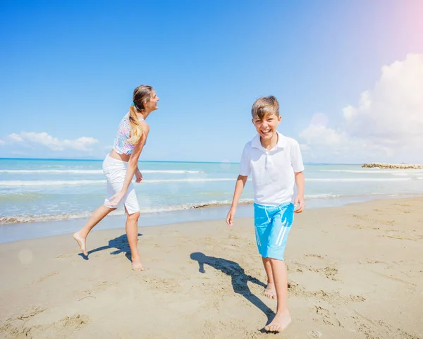 Adorables niños se divierten en la playa . — Foto de Stock