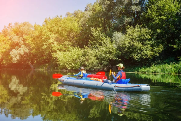 Glückliche Kinder beim Paddeln auf dem Fluss an einem sonnigen Tag in den Sommerferien — Stockfoto