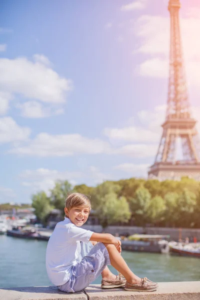 Fiú ül és néz le közel az Eiffel-torony — Stock Fotó
