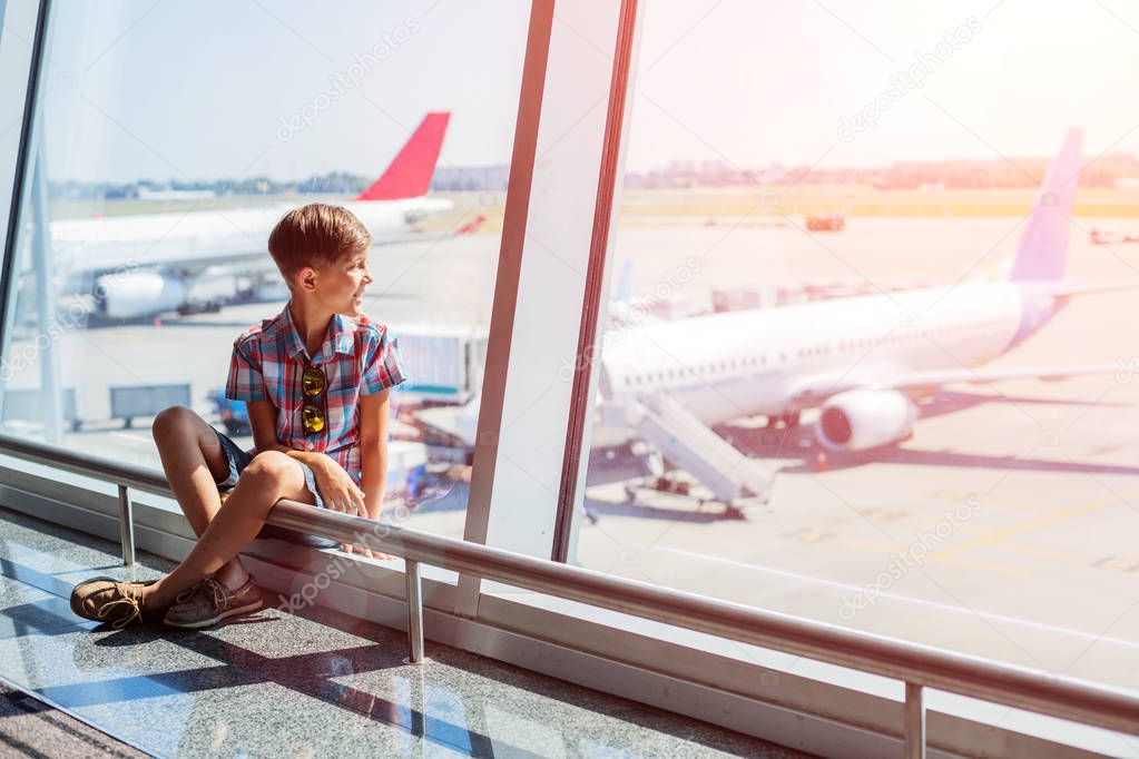 Boy looking at planes in the airport