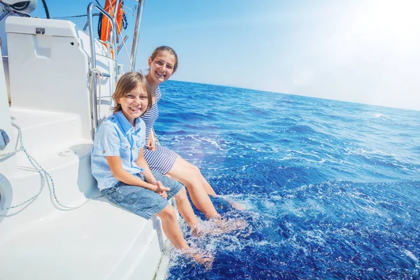 Boy with his sister on board of sailing yacht on summer cruise. — Stock Photo, Image