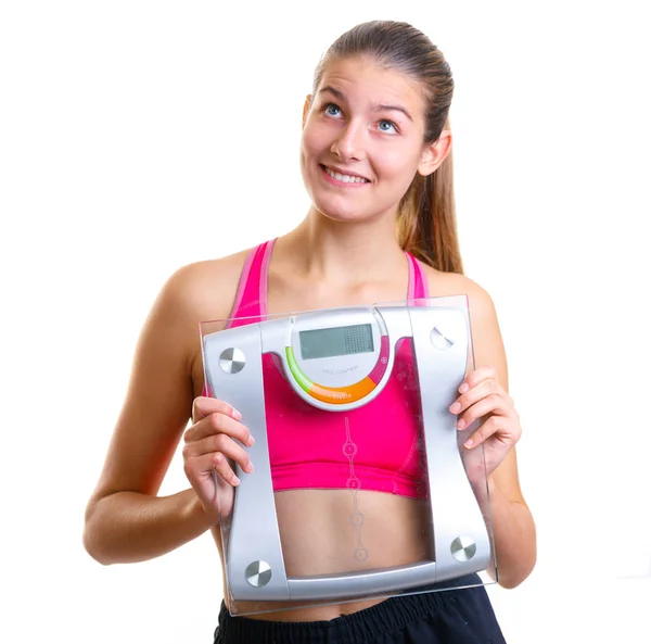 Beautiful young happy girl holding scales, isolated — Stock Photo, Image