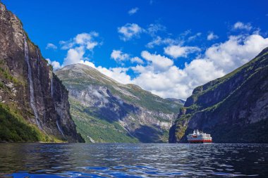 Hurtigruten cruise liner sailing on the Geirangerfjord, one of the most popular destination in Norway clipart