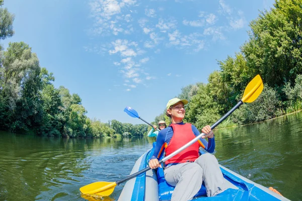 Gelukkig familie kajakken op de rivier op een zonnige dag tijdens de zomervakantie — Stockfoto