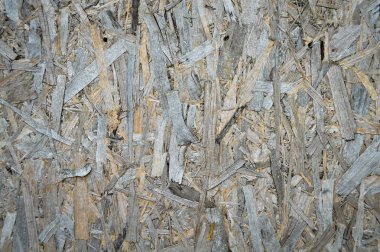 Preslenmiş çam ağacı yongalarından oluşan osb plakası. Eski ve yıpranmış. Tahıl, soyut.