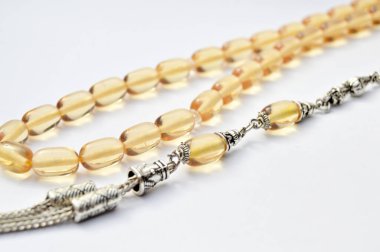 Turuncu ve gümüş boncuklar sıralı, kısa tespih tesbih, Türk kültürü için önemli bir aksesuar, beyaz arka planda izole edilmiş.