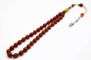 Turuncu ve gümüş boncuklar sıralı, kısa tespih tesbih, Türk kültürü için önemli bir aksesuar, beyaz arka planda izole edilmiş.