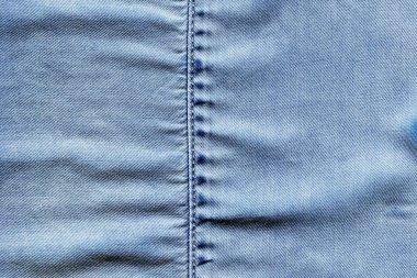 Dikilmiş açık mavi kot kot pantolon kumaş kumaş arka plan ve duvar kağıdı